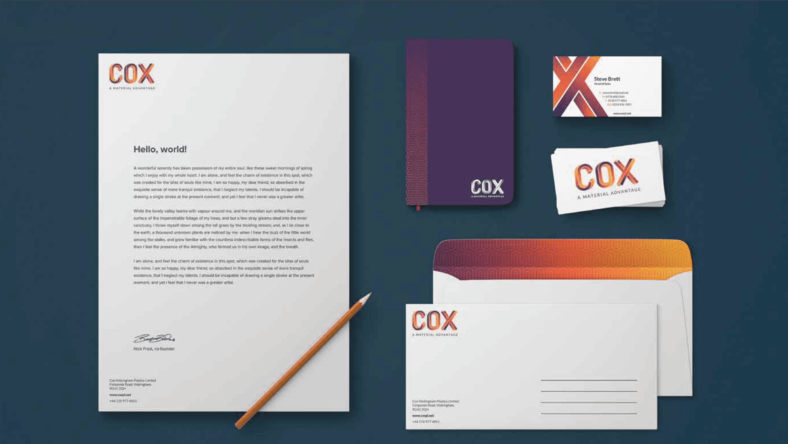 COX branded stationery set with letterhead, notebook, business cards, and envelopes on dark blue background.